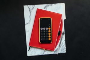 A calculator on a red folder