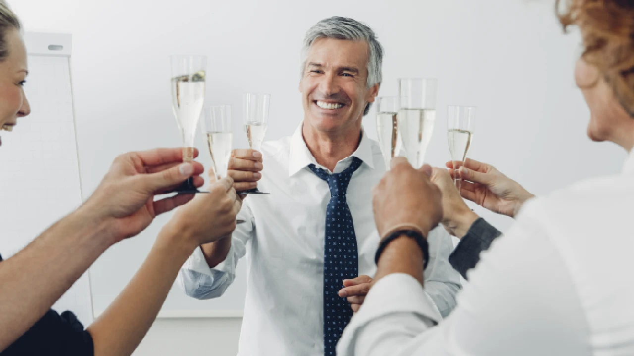 A team celebrating success with champagne, representing hard money lenders in New York maximizing returns