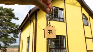 Do Hard Money Lenders Require a Down Payment? 3 Hands holding a key in front of a house