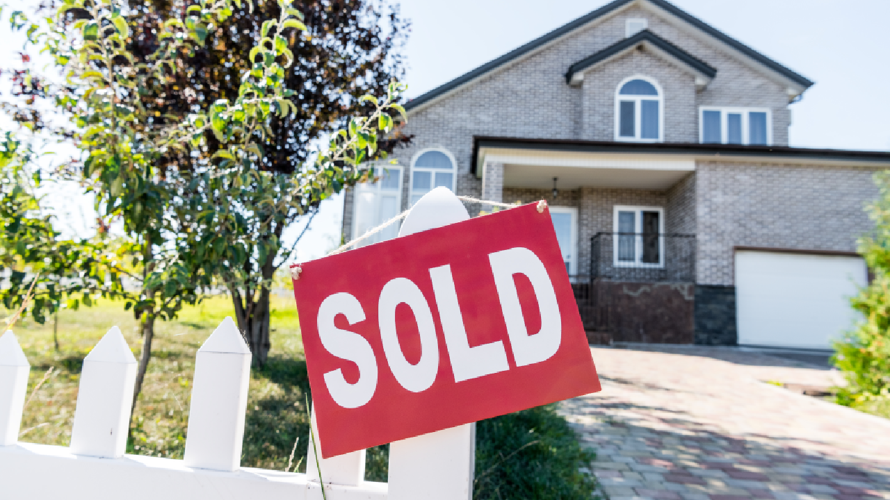 Sold sign in front of a a house