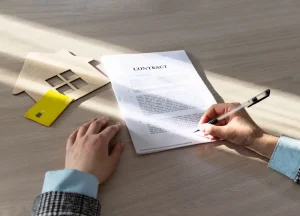 NY Hard Money Loans for Rental Properties: What Investors Need to Know 3 A business contract ready to be signed, placed on a desk with a pen beside it, symbolizing a financial agreement.