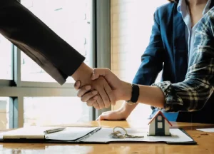 The Benefits of Working with Local Hard Money Lenders in NY 2 real estate investor shaking hands with a local hard money lender