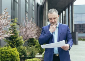 How to Secure Your First Deal with a Hard Money Lender in NYC 2 Investor reviewing property documentation for a hard money loan
