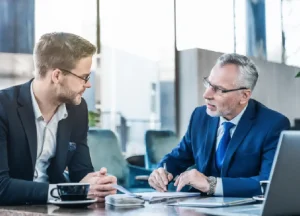 5 Common DSCR Loan Myths That Stop Investors from Growing 4 Real estate investor consulting with a financial advisor to evaluate DSCR loan options and investment strategy.