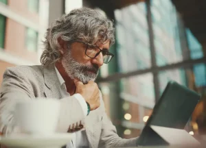 5 Common DSCR Loan Myths That Stop Investors from Growing 3 Real estate investor reviewing rental property cash flow on a laptop to evaluate DSCR loan stability.
