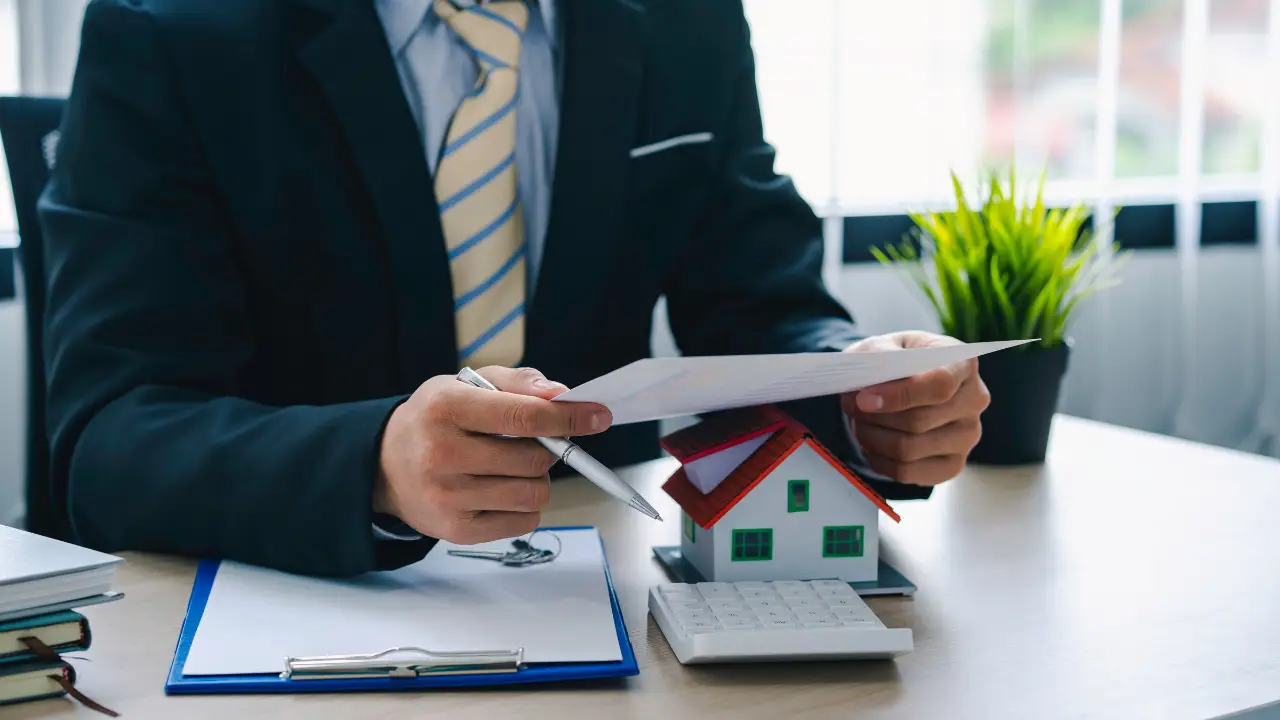 Real estate investor reviewing financial documents while analyzing DSCR loan options for rental properties.