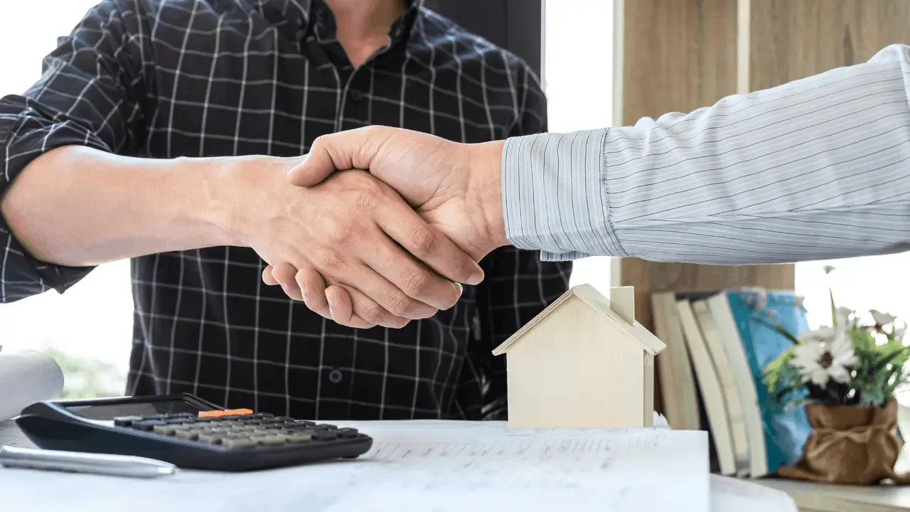 Investor reviewing a property with a clipboard or tablet outside a house