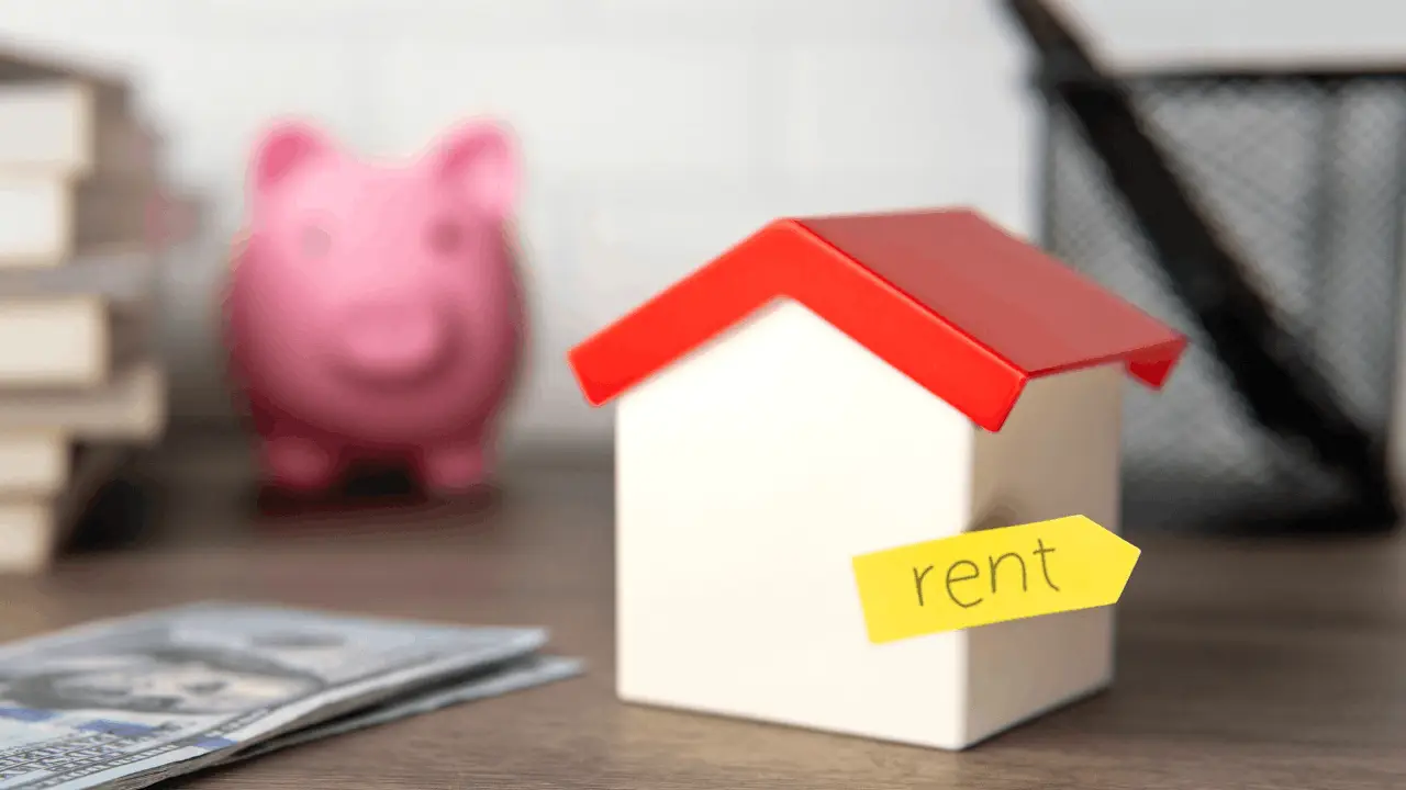 Modern rental property or duplex with “For Rent” sign and calculator on table (investment concept)